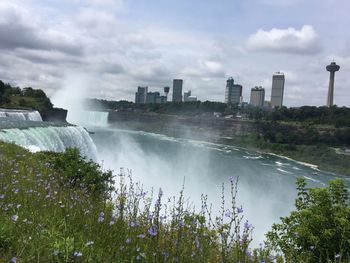 Panoramic view of river and city against sky