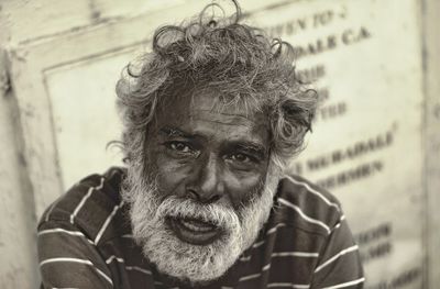 Close-up portrait of senior man sitting outdoors