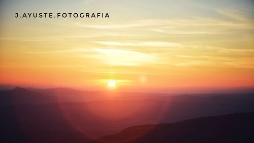 Scenic view of sunset over mountains