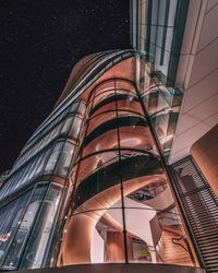 Low angle view of modern building against sky at night