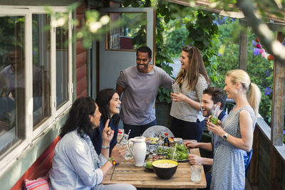 High angle view of happy multi-ethnic friends enjoying party at log cabin