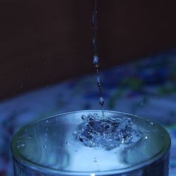 Close-up of water splashing in glass