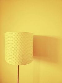 Close-up of electric lamp against wall