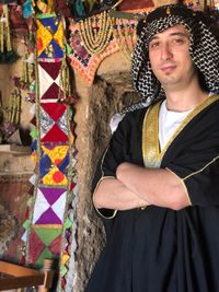 Portrait of man in traditional clothes standing indoors