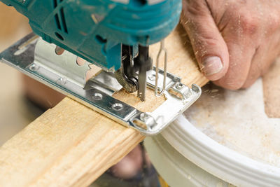 Close-up of man working on wood