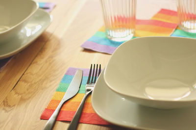 Preparing diner table during pride month. using lgbt's flag colored napkins.