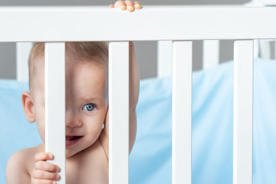 High angle view of baby boy lying on bed