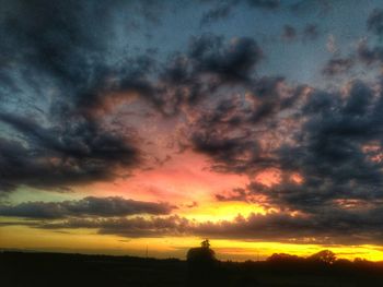 Dramatic sky over silhouette landscape during sunset