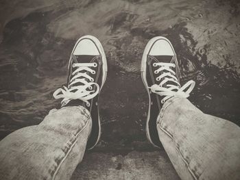 Low section of man standing on tiled floor