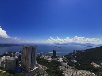 Aerial view of buildings in city against sky