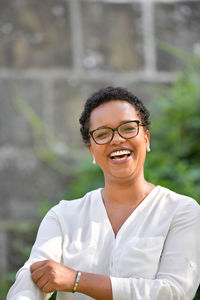 A young pretty african american businesswoman in a park with summer temperatures.