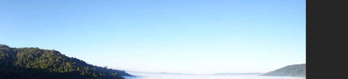 Scenic view of mountains against clear blue sky