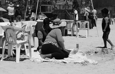 Group of people sitting on sand