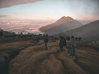 Rear view of people walking on land