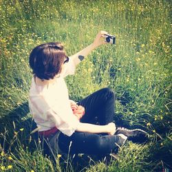 Woman standing on grassy field