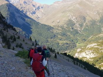 Rear view of man photographing on mountain