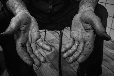 High angle view of man sitting on hand