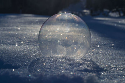 Close-up of glass ball on snow