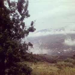 Scenic view of river against cloudy sky