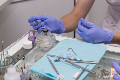 Midsection of nurse holding equipment