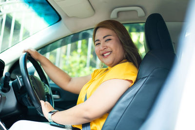 Portrait of woman sitting in car