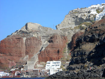 Low angle view of rocks against blue sky