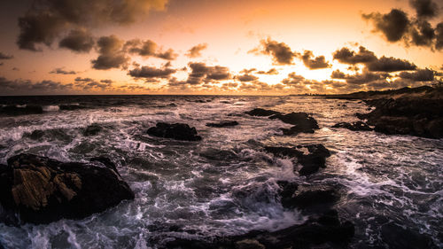 Scenic view of sea against cloudy sky
