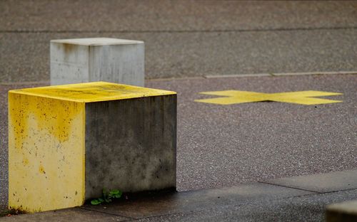 Close-up of yellow arrow symbol on wall