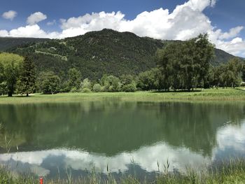 Scenic view of lake by trees against sky