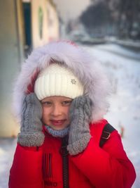 Portrait of smiling girl wearing hat during winter