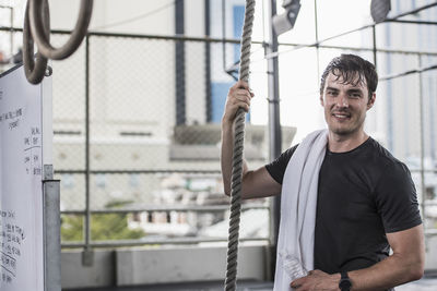 Man looking at camera while training at rooftop gym in bangkok