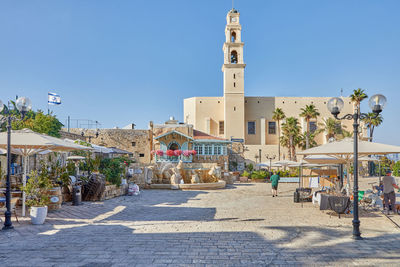 Central square of old jaffa with fountain of zodiac signs, restaurants and the church 