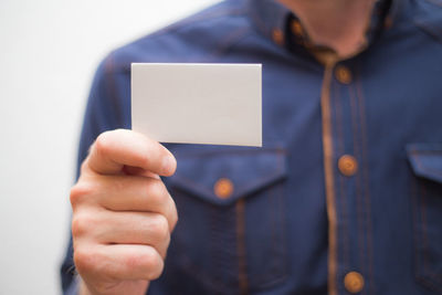 Close-up of man holding smart phone