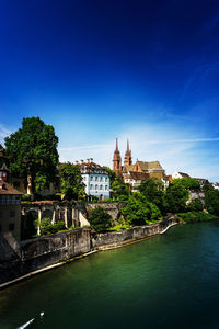 River by church in city against sky