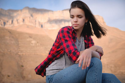 Beautiful woman sitting on a desert