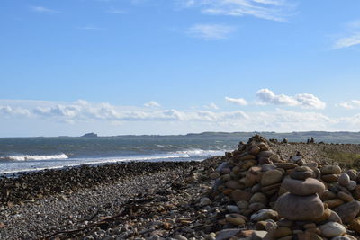 Rocks on beach against sky