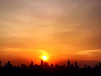 Silhouette of city during sunset