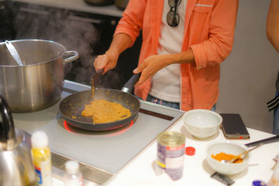 Midsection of man preparing food