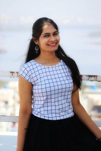 Portrait of smiling young woman standing outdoors