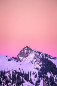 Snow covered mountain against sky during sunset