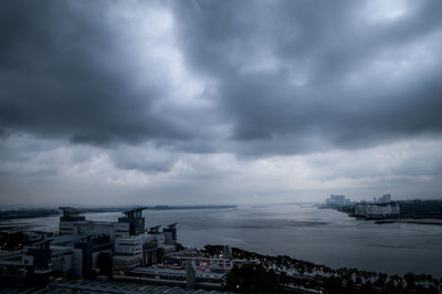 View of cityscape against cloudy sky