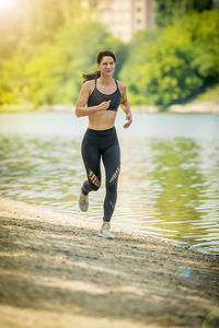 Full length of young woman running