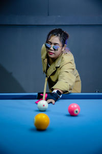 Portrait of woman playing pool