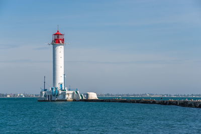 Lighthouse at the entrance to the harbor of odessa seaport, on a sunny summer day