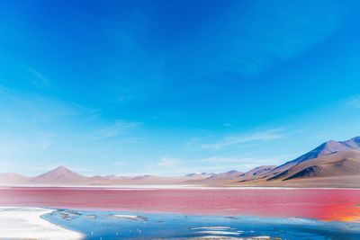 Scenic view of landscape against blue sky