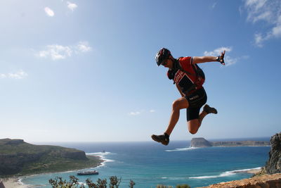 Woman jumping on beach