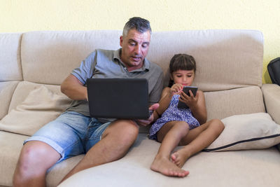 Father with daughter doing homework at home