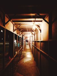 Empty corridor in illuminated building