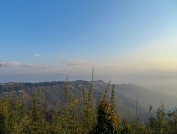 Scenic view of mountains against sky at sunset