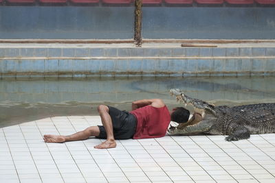 Full length of boy sleeping in swimming pool